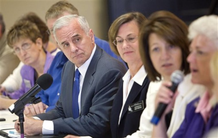 Minnesota Governor Mark Dayton listens to members of the public explain how state budget cuts would affect them at a roundtable discussion on Wednesday.